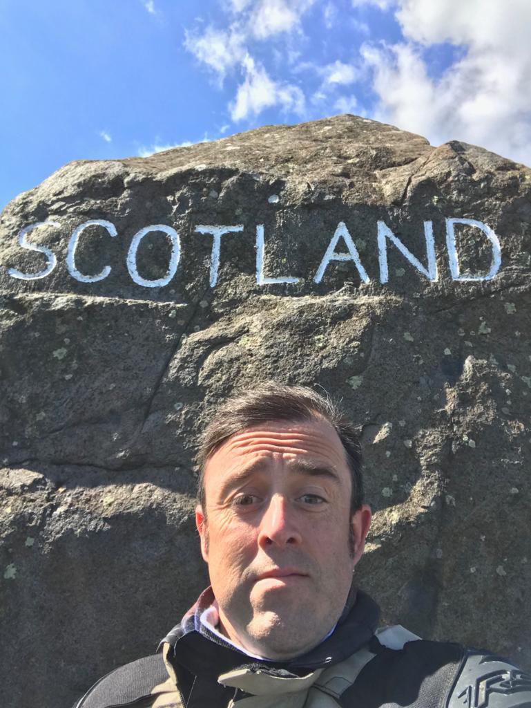 man with scotland sign